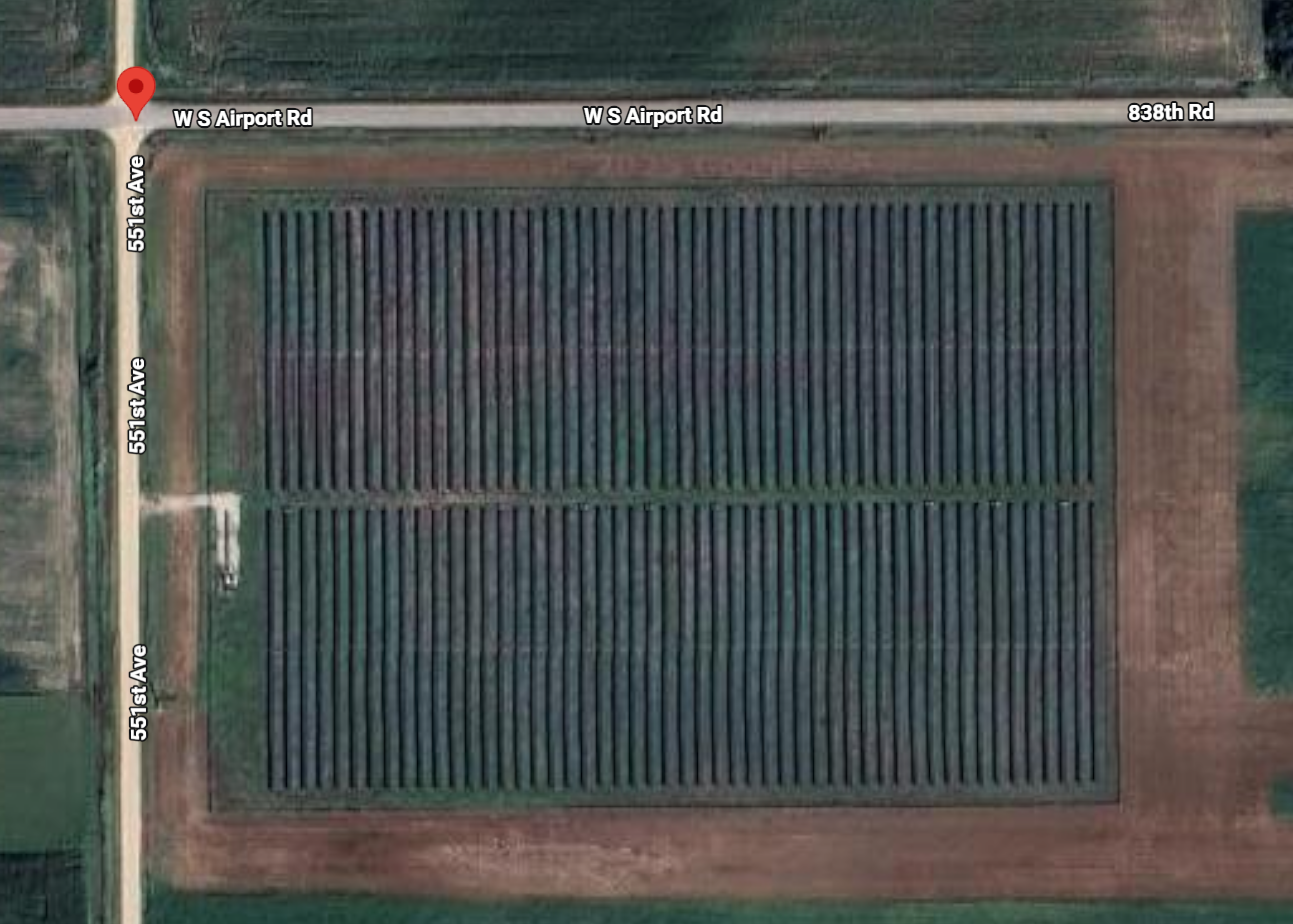 A large rectangular field with solar panels on a map, labeled with streets and coordinates.