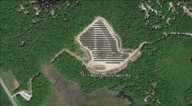 A solar farm surrounded by green forest on a map.